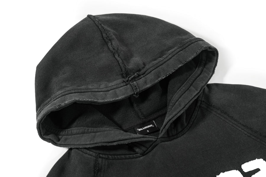 Acid wash black hoodie with a 'BLURRR' brand logo on a white background