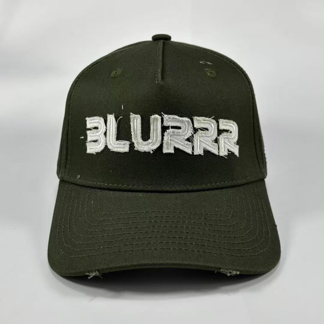 An olive green distressed baseball cap featuring the word 'BLURRR' embroidered in white across the front, set against a plain light gray background.