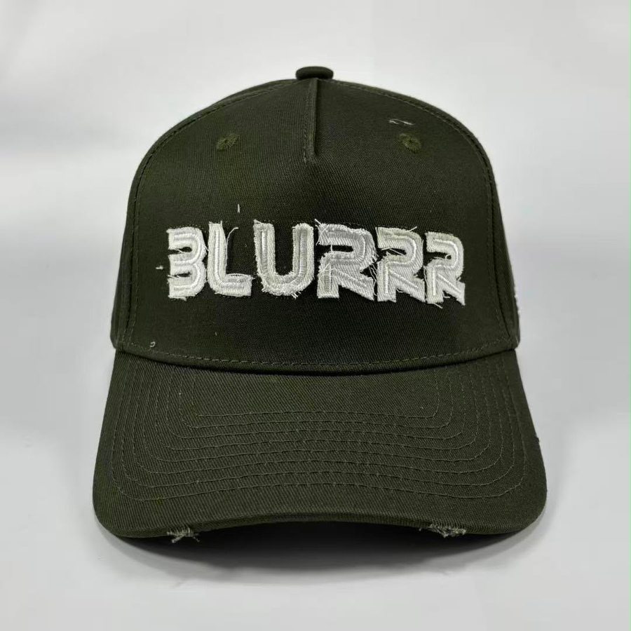 An olive green distressed baseball cap featuring the word 'BLURRR' embroidered in white across the front, set against a plain light gray background.