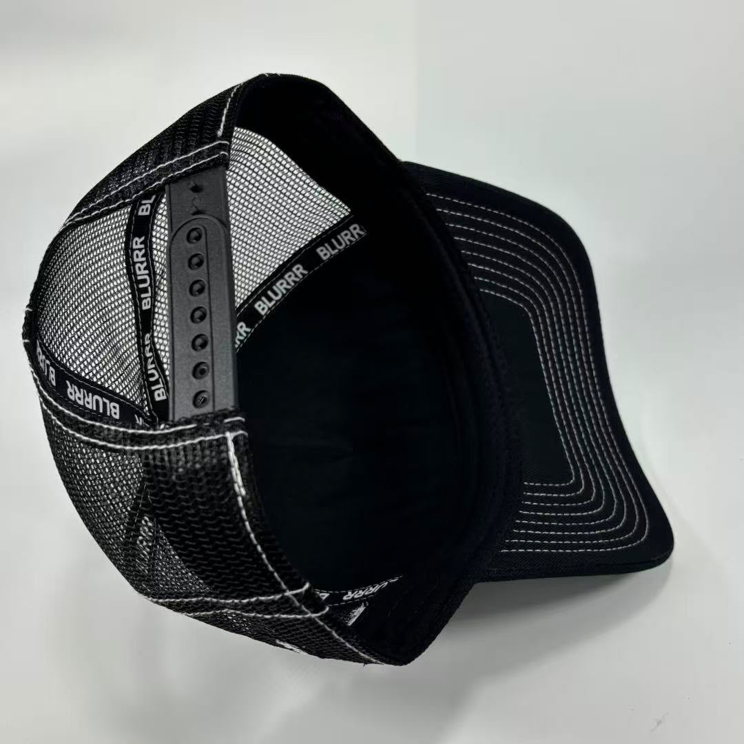 Black mesh trucker cap with white contrast stitching and adjustable snap closure, shown on a light gray background.