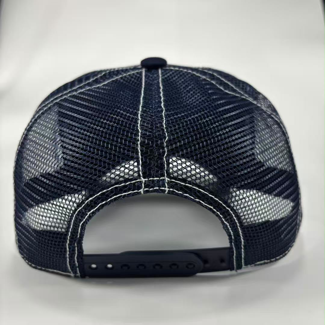 A dark navy blue trucker-style baseball cap shown from the back, featuring a mesh back with white contrast stitching and an adjustable snap closure.