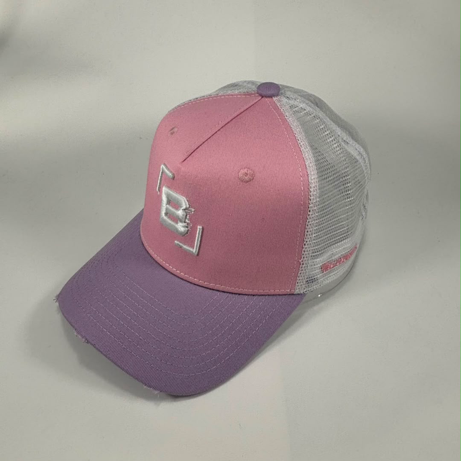 A pink and purple trucker cap with a white embroidered 'B' logo on the front, featuring a pink front panel, purple brim, and white mesh back panels.