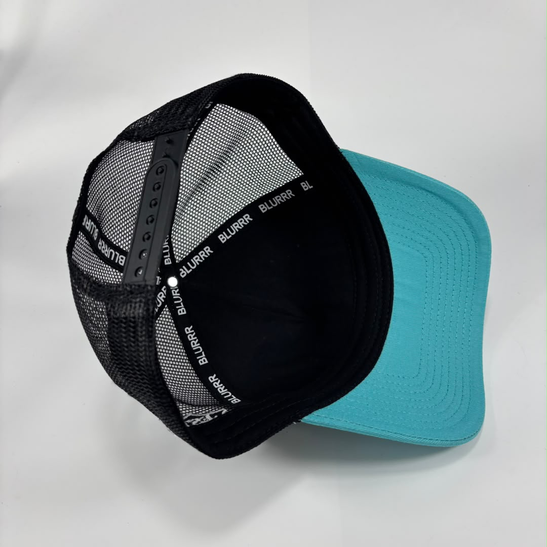 A trucker-style baseball cap with a black mesh back and a bright turquoise flat brim, shown on a light gray background. The back band is black with the brand name 'BLURRR' repeated in white.